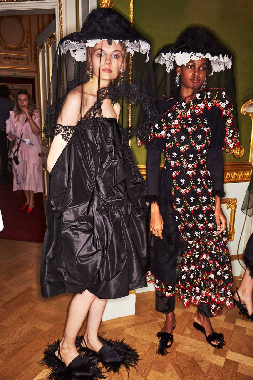  Models backstage at the Simone Rocha Spring/Summer 2019 show wearing her signature accessories for the season – tower hats and fluffy slides and sandals – and the two silhouettes of voluminous or more form-grazing silks and tulle. Credits: KIM WESTON ARNOLD / INDIGITAL.TV