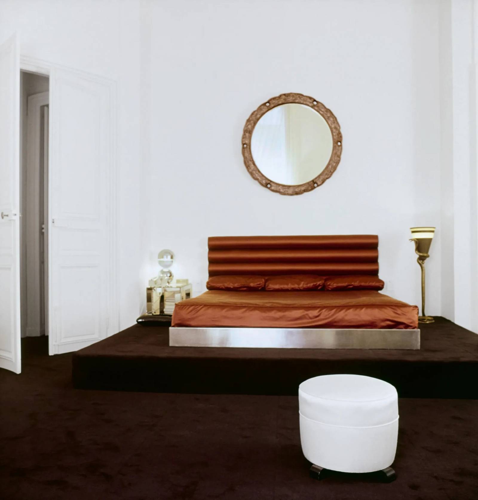 W sypialni na platformie pokrytej czekoladowo-brązową wykładziną znajduje się łóżko z metalową podstawą z poprzedniego mieszkania, uzupełnione za-główkiem ze skóry warstwowej, którego projekt przypisuje się Eugène Print-zowi.