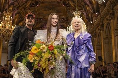 Andreas Kronthaler (left) and model Bella Hadid present Vivienne Westwood with a bouquet
© Peter White / Getty