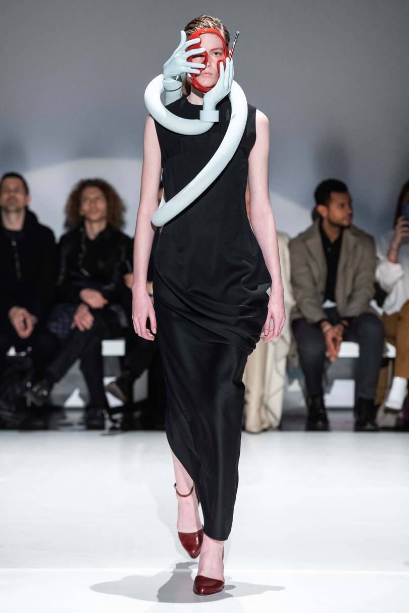 A sculpture of head and hands adds a surreal touch to a black-leather dress. Credit: FILIPPO FIOR / GORUNWAY.COM