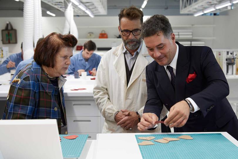 Massimo Rigucci and Suzy watch a young student of Guccis Scuola dei Mestieri practice her craft. Credit: GUCCI