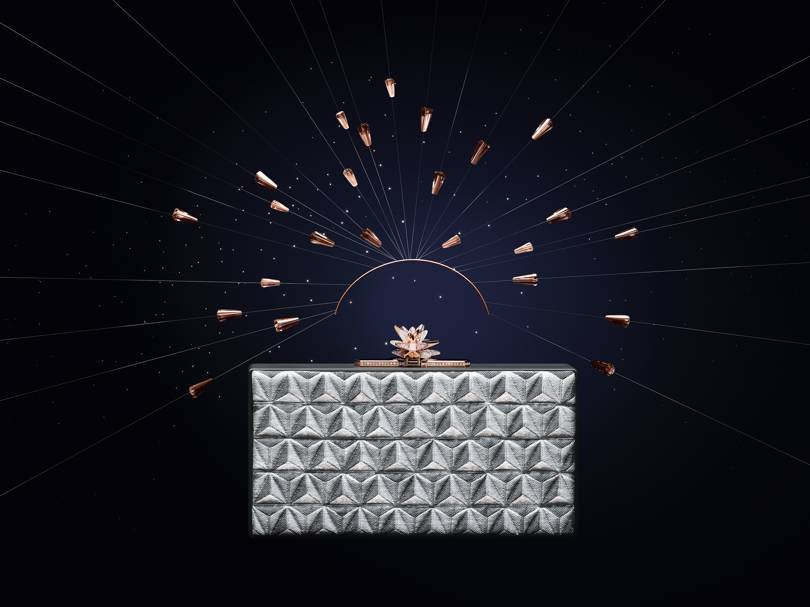 Les Galaxies de Cartier collection metallic-jacquard clutch bag with a pink gold, diamond and milky quartz clasp that transforms into a brooch. Credit: CARTIER