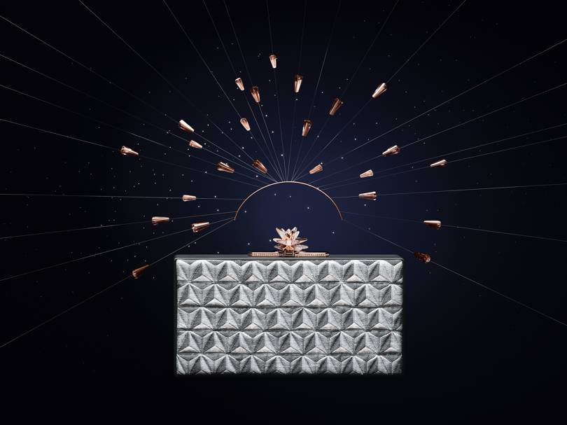 Les Galaxies de Cartier collection metallic-jacquard clutch bag with a pink gold, diamond and milky quartz clasp that transforms into a brooch. Credit: CARTIER