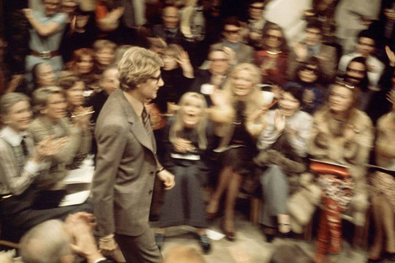Yves Saint Laurent, Spring/Summer 1974, Paris. During these earlier years of fashion shows, there was no podium for photographers. “We all had to put ourselves where we could and I stood perched on the windowsill of the salon – it was a great position to see Yves’ front row going wild for him in the finale, Chris Moore remembers. Credit: Chris Moore