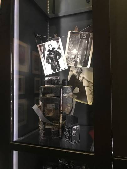 A display case featuring Chris Moores pit box – a camera case that doubles as a stand for Moore so he can shoot above his catwalk colleagues when he is in the photographers pit at the end of the catwalk. Credit: SuzyMenkesVogue