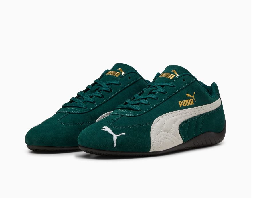 Zielone sneakersy Puma z białymi detalami i złotym logotypem, idealne do codziennych stylizacji.