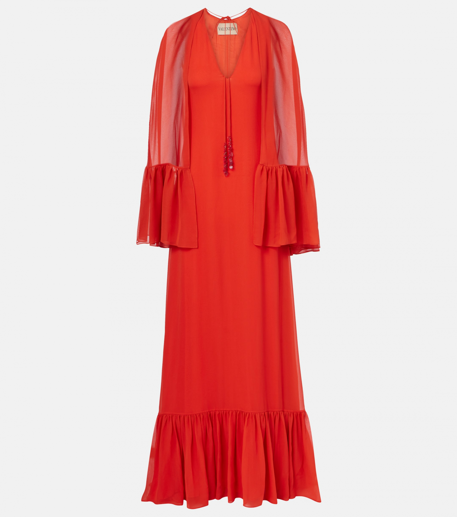 Pomarańczowa sukienka maxi w stylu boho od Valentino z bufiastymi rękawami i falbaną na dole.
