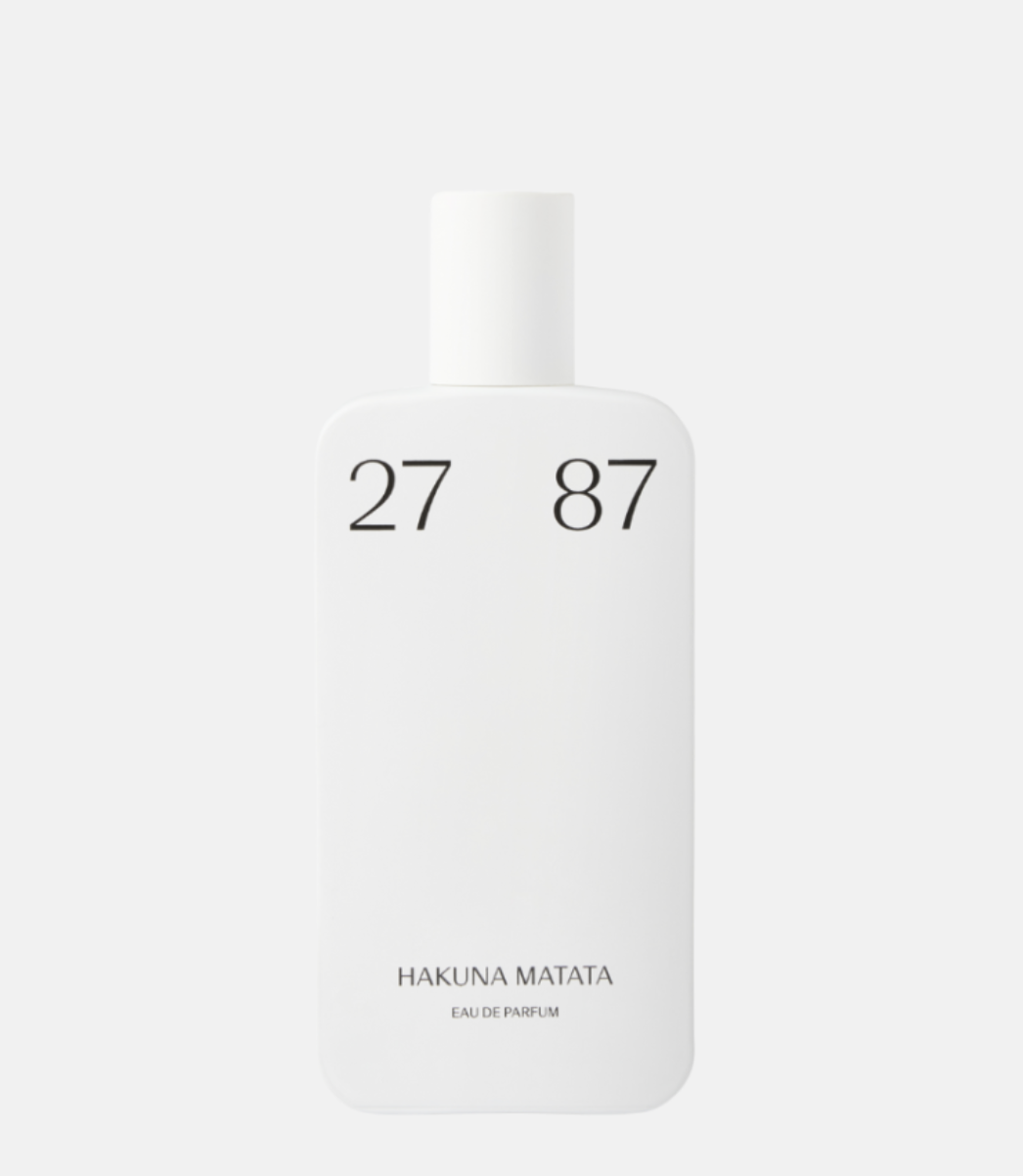 Biały flakon perfum z minimalistycznym designem, oznaczony numerami 27 87 i napisem "HAKUNA MATATA".