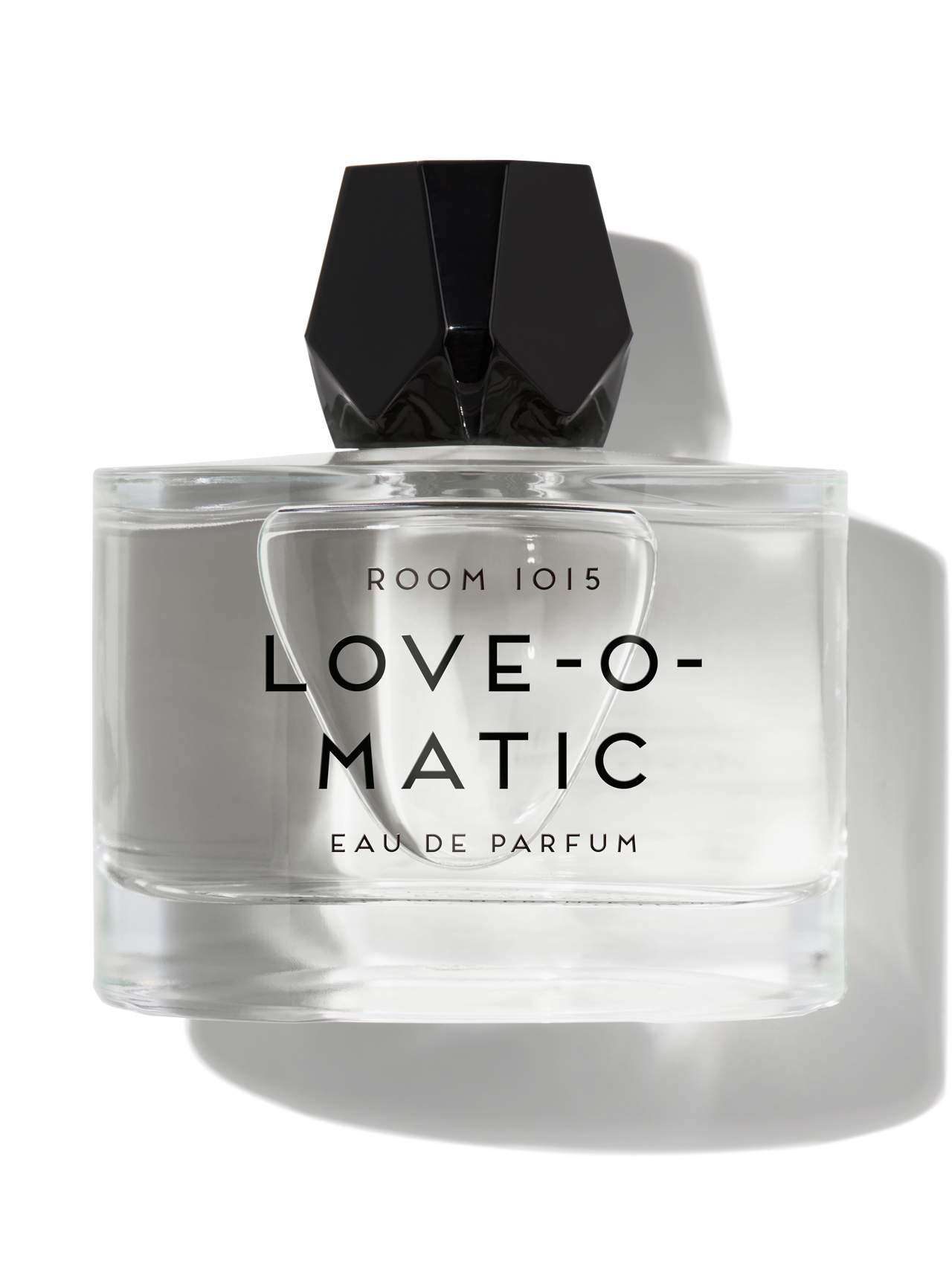 Butelka perfum Love-O-Matic z czarną nakrętką. Przeźroczysta, minimalistyczna forma z widoczną etykietą.