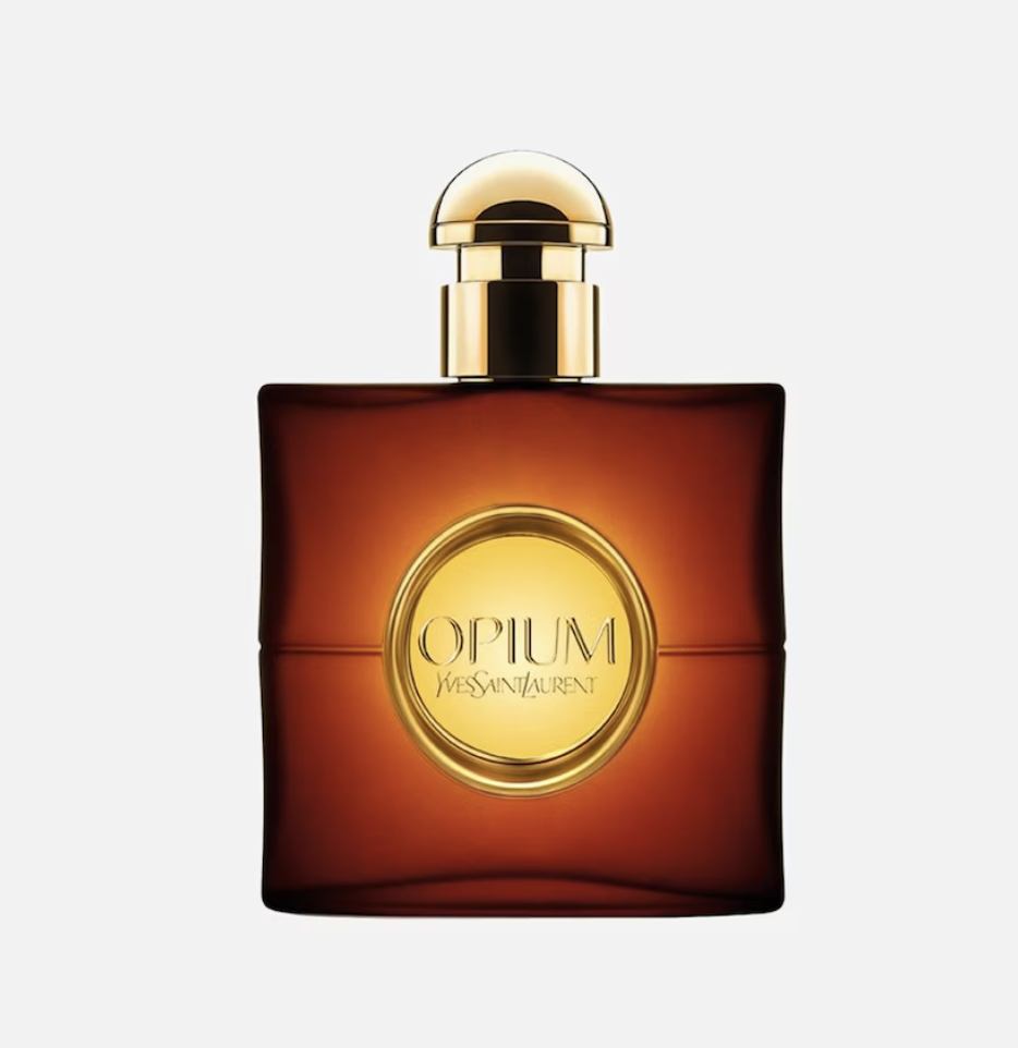 Perfumy na jesień w eleganckiej butelce OPIUM od Yves Saint Laurent, w odcieniach złota i brązu.