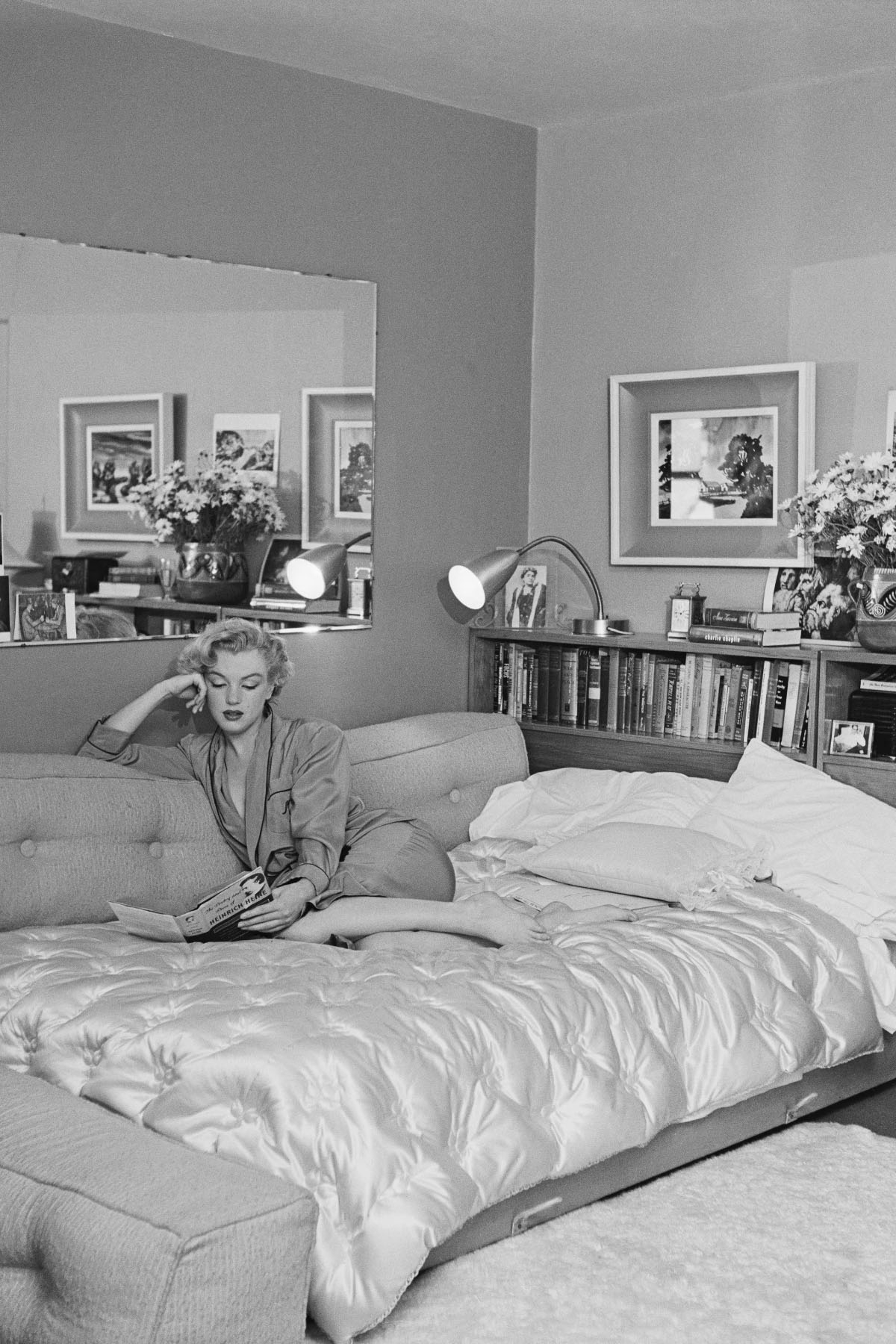 Amerykańska aktorka Marilyn Monroe (1926–1962) odpoczywa na sofie, około 1951 roku. Czyta książkę „Poezja i proza Heinricha Heinego” (Fot. Archive Photos/Getty Images)