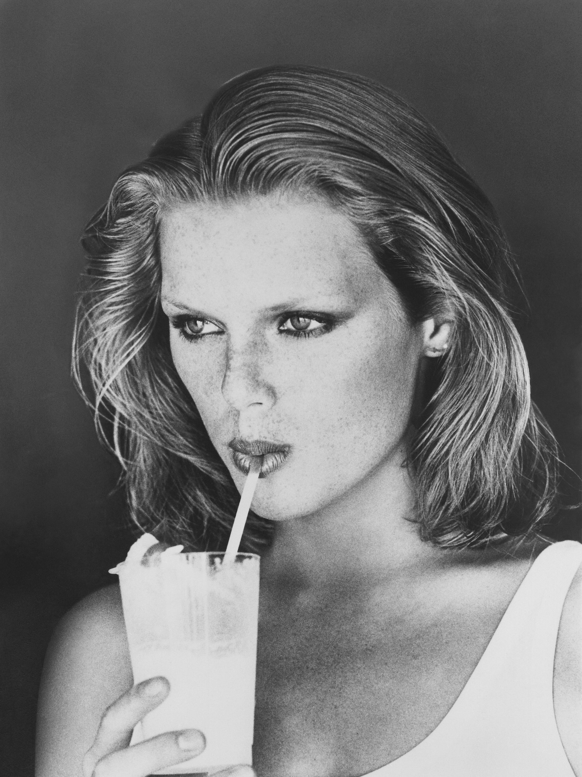 Modelka Patti Hansen pije napój ze szklanki przez słomkę.(Fot. Arthur Elgort/Conde Nast via Getty Images)