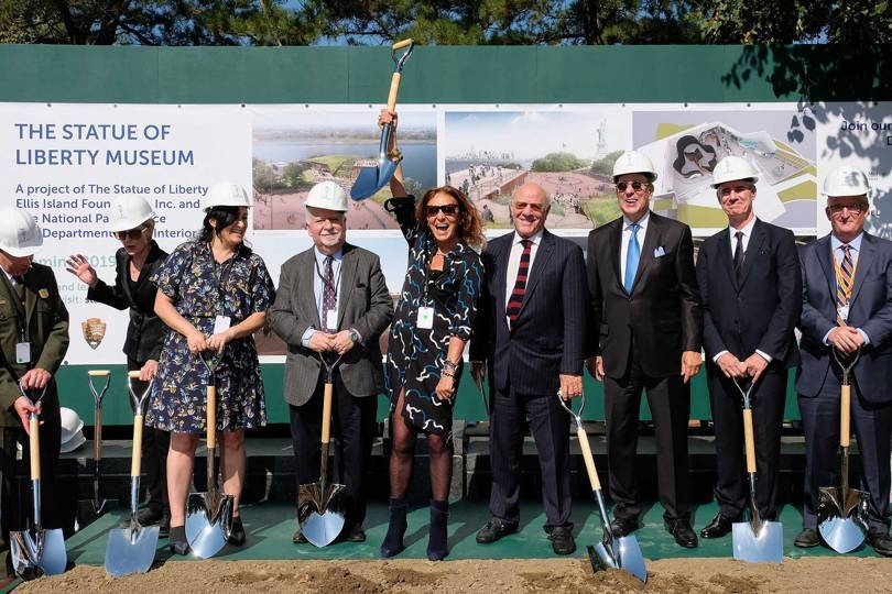 Diane von Fürstenberg (centre, arm raised) and her husband Barry Diller (beside her in red striped tie), join Statue of Liberty-Ellis Island Foundation President and CEO Stephen Briganti (in white helmet beside DvF) at the laying of the foundations for the Statue of Liberty Museum in 2016
Credit: GETTY IMAGE